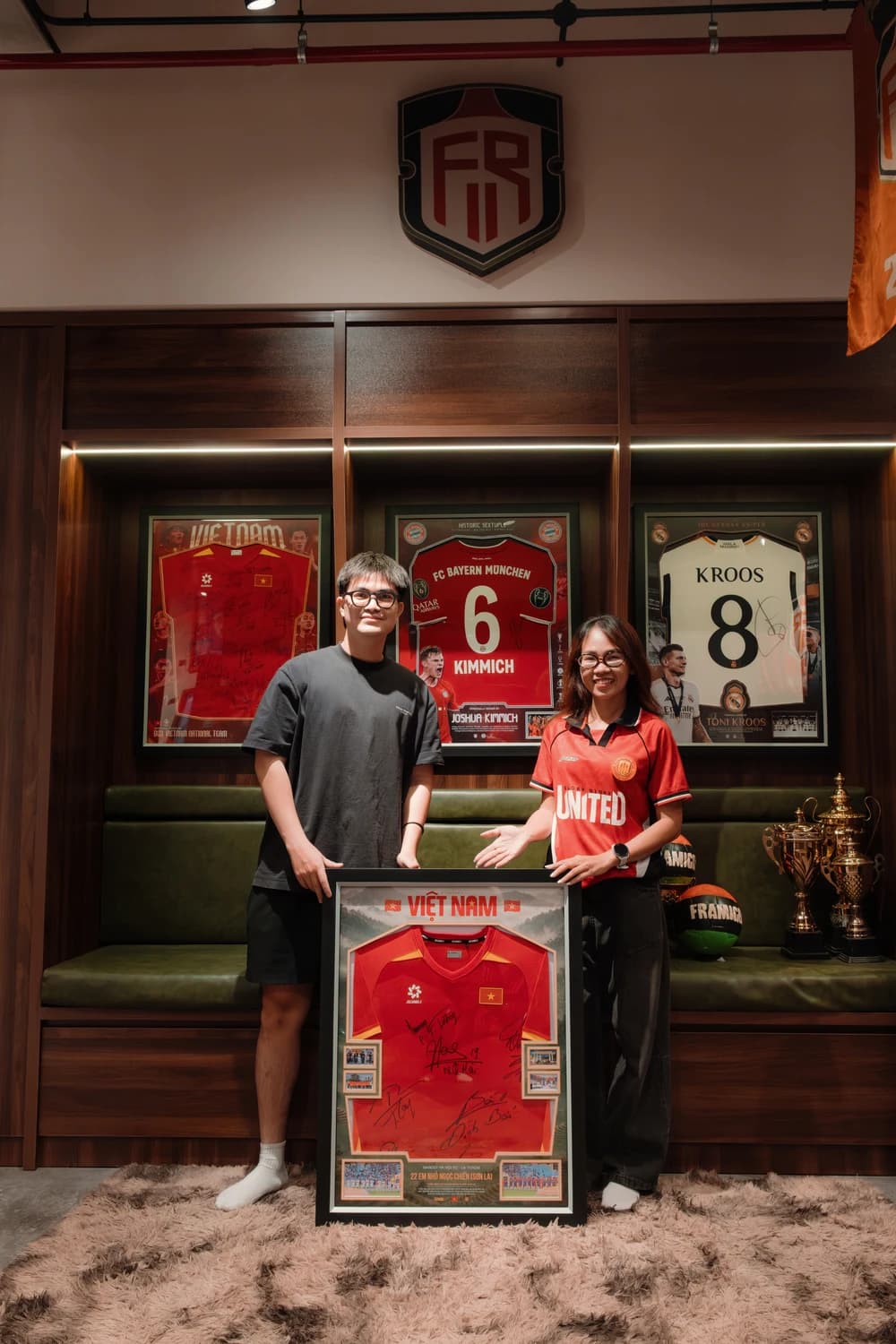 Framigos and Hoops 4 Hope presenting a framed Vietnam jersey